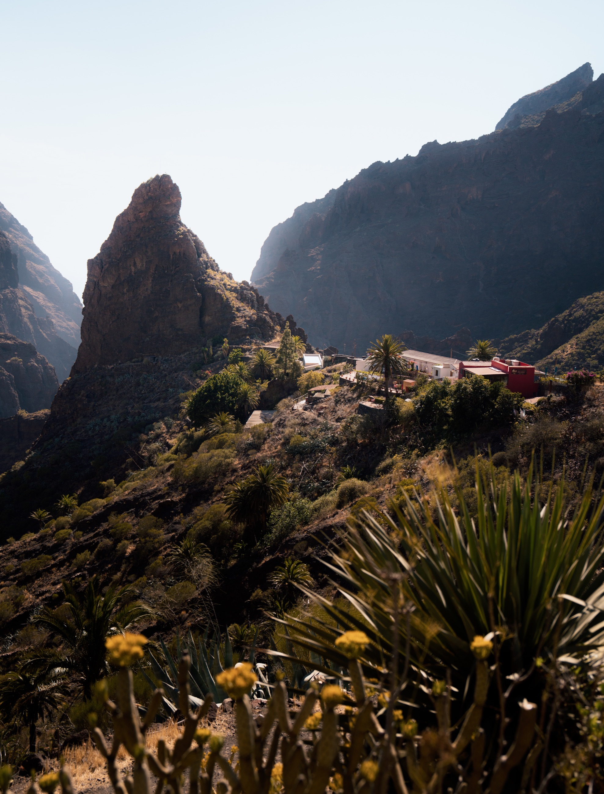 Sunlit rock formations and hillside buildings in Masca, Tenerife