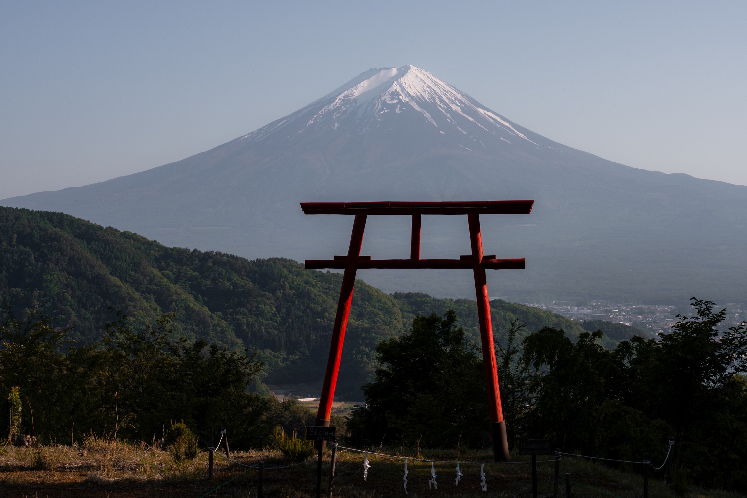 Mount Fuji framed by a red torii gate in Japan