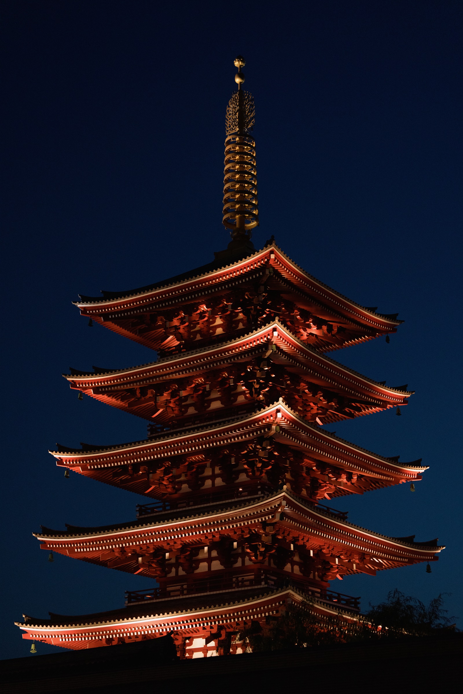 Illuminated Japanese pagoda against the night sky in Tokyo